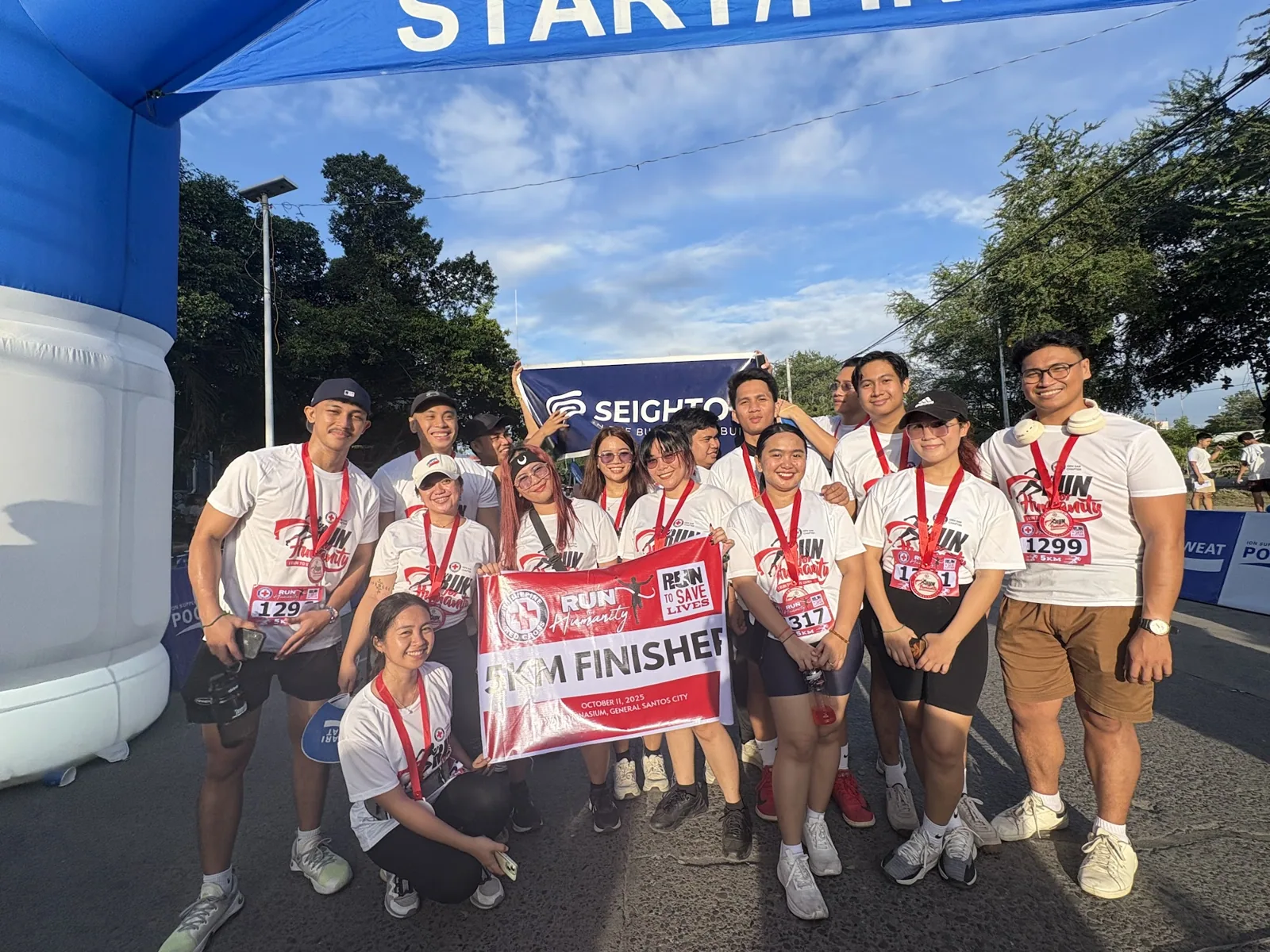 The team under the start and finish arch
