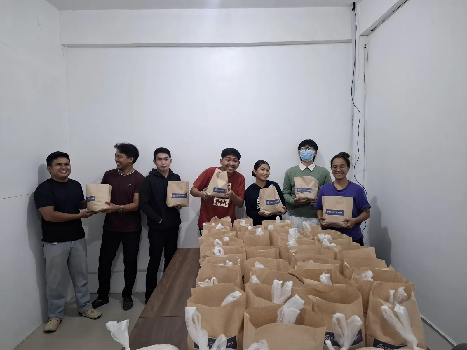 Seighton staff holding their monthly rice allowance